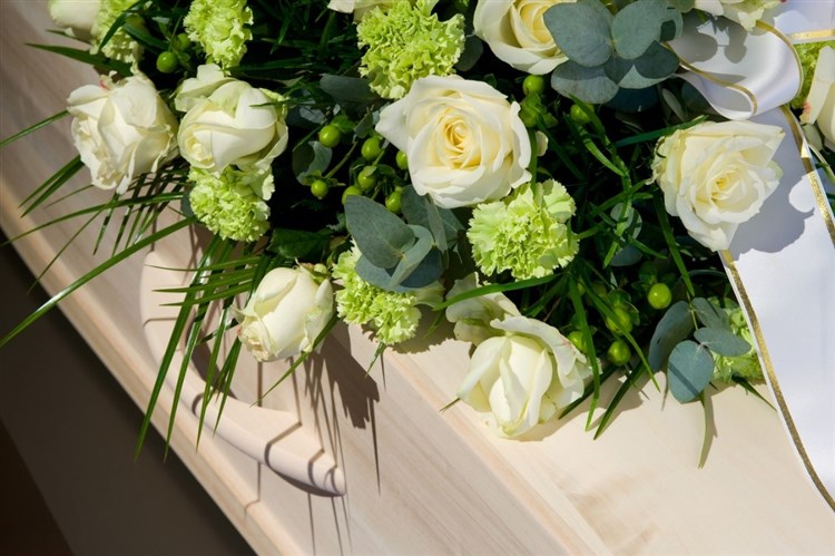 Funeral flowers on coffin